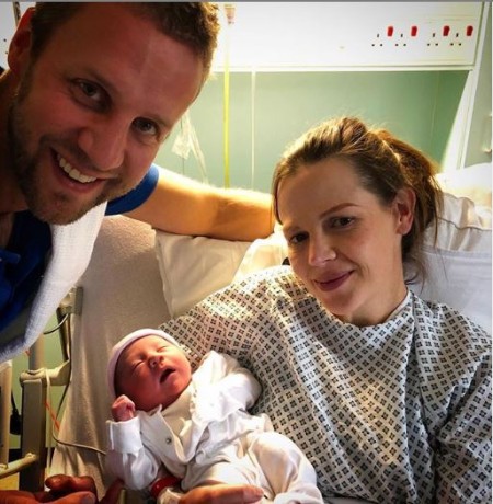 Alexis Green with her new born baby daughter and her partner Johnnie Foster
